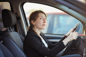 Fototapeta na wymiar Young woman in a car