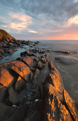 Stones on the coast, lit by the sun.