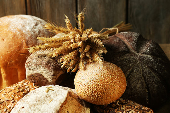 Different bread on table on wooden background