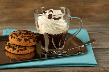 Cup of coffee with cream and cookies