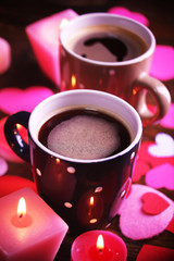 Two cups on table with candles and decor close-up