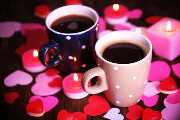 Two cups on table with candles and decor close-up