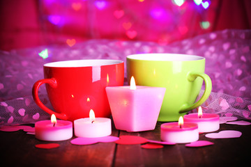 Two red cups on table on lights background