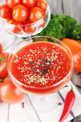 Tomato juice in goblet and fresh vegetables