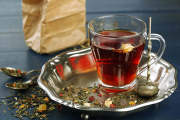 Beautiful vintage composition with herbal tea, on wooden table
