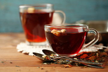 Beautiful vintage composition with herbal tea, on wooden table