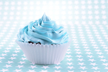 Delicious cupcake on light background