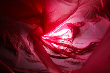 Abstract background of the insides of a red plastic bag