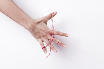 Woman hand with red string