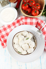 Meat dumplings with sauce on plate on table close-up