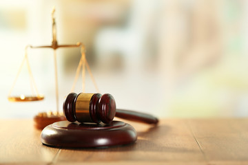 Wooden judges gavel on wooden table, close up