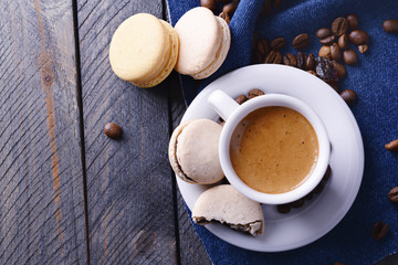 Gentle colorful macaroons and  coffee in mug