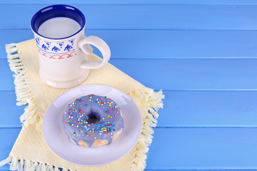 Glazed donut with cup of milk