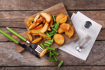 Breaded fried chicken nuggets and potatoes with asparagus