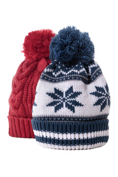 Two chunky knit warm winter bobble knit hats ski clothing isolated white background photo