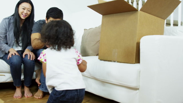 Smiling Ethnic Couple Playing Infant Girl New Home 