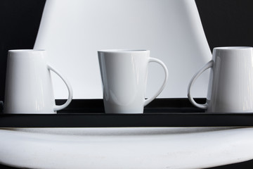 Three white mugs on tray