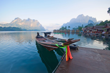 Long-tail boat and lakeside raft houses on Cheow Lan Lake, Khao