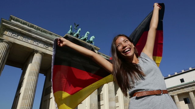 German flag woman happy at Berlin Brandenburger Tor