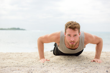 Push-up crossfit man fitness training on beach