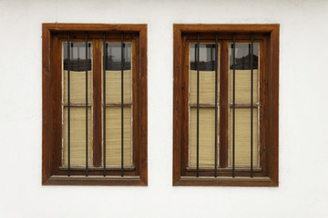 Two bulgarian old windows on white wall