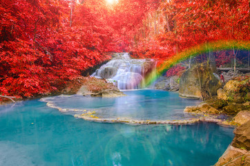 Fototapeta na wymiar Wonderful Waterfall with rainbows and red leaf in Deep forest at