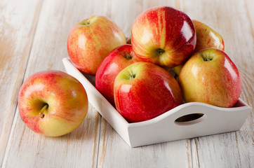 Fresh red  apples  on  wooden table