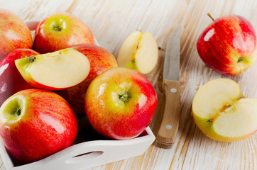Fresh red apples  in white box on  wooden table
