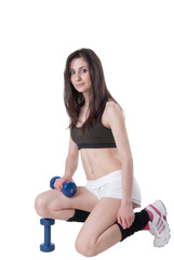 Young athletic woman holding a dumbbells