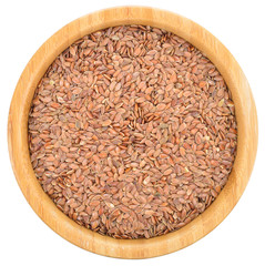 Brown flax seeds in wooden bowl isolated.