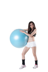 Young athletic woman with blue exercise ball