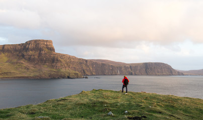 Man trekking through Scottish highland seascape
