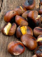 roasted chestnuts on wooden surface