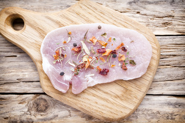 Pork chop, meat slices  on a wood background.
