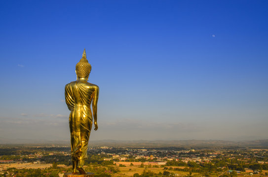 Stand gold buddha of cityscape