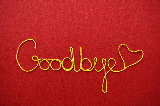 goodbye ribbon greeting and hearts on red background
