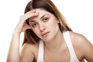 tired young woman on white background