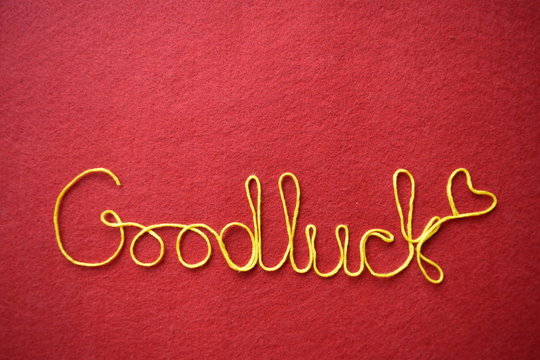 goodluck ribbon greeting and hearts on red background