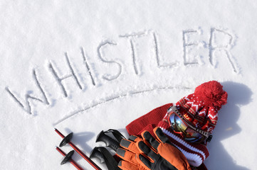 Whistler word written in snow with equipment and clothing skiing vacation holiday concept photo
