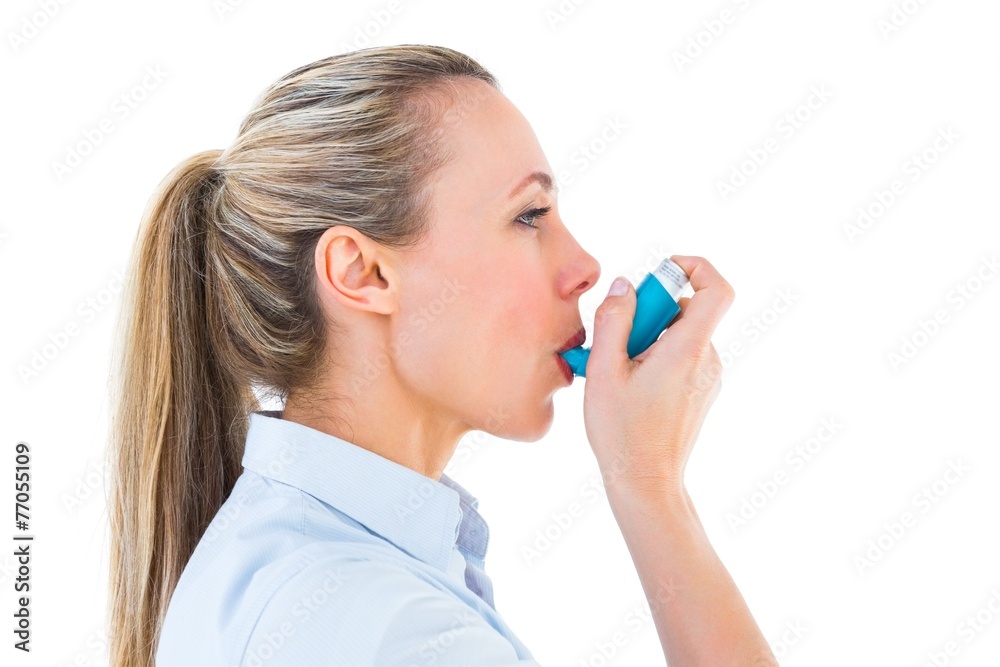 Poster pretty blonde using an asthma inhaler