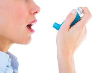 Close up of a woman using an asthma inhaler