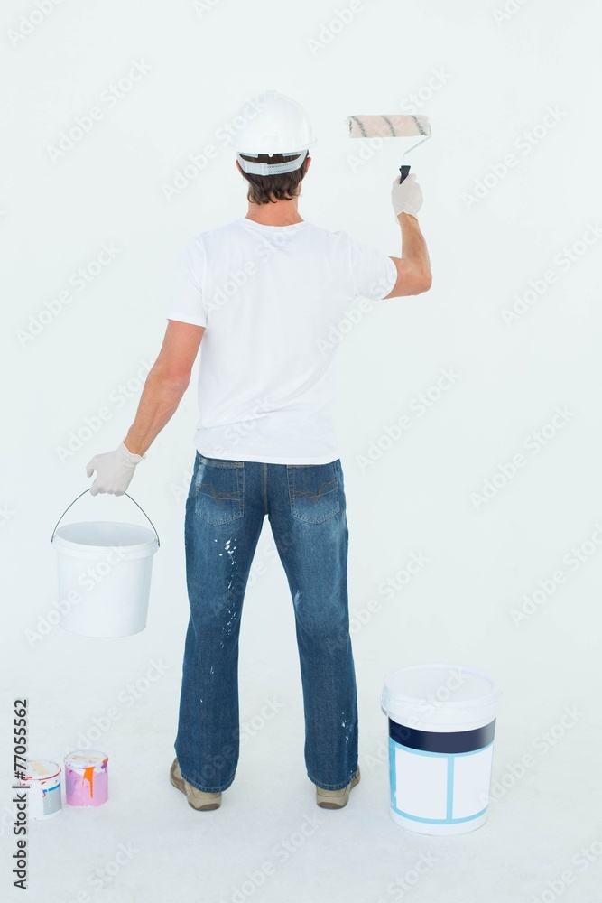 Aufkleber Rear view of man using paint roller