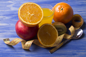 Fruits with measuring tape with wood background