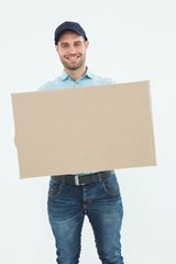 Courier man carrying cardboard box