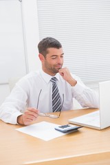 Fototapeta premium Businessman looking his laptop at his desk