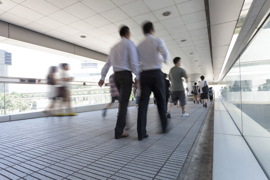 people walking through the airport corridor
