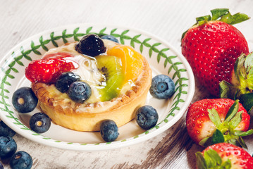 Delicious cookie made shortcrust pastry with fresh fruit, strawb