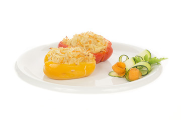 Red and Yellow stuffed peppers on dish isolated on white