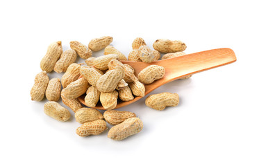 Peanuts in wooden spoon on white background