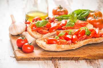 Italian starter, bruschetta with Sicilian red fresh tomato on a